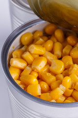 Canned corn in a iron can on white background