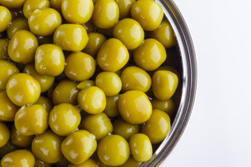 Canned green peas in a iron can on white background