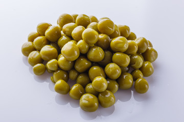 canned green peas on a white acrylic background