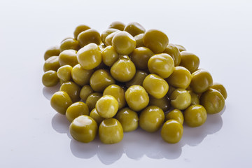 canned green peas on a white acrylic background