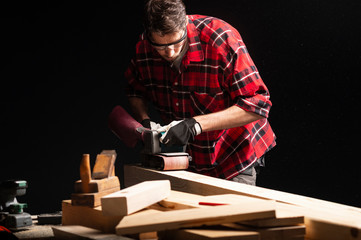 Carpenter works with electrical planer