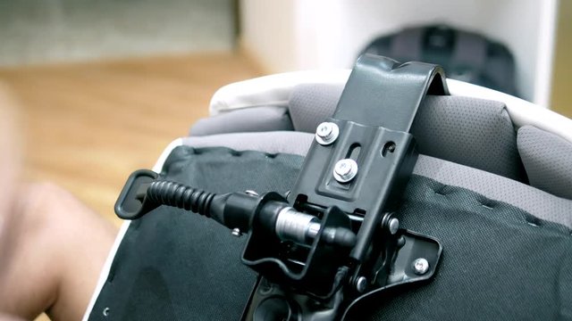 a young man is assembling an office chair. The concept of repair and assembly of furniture