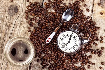 Fresh coffee and retro alarm clock. Concept of getting up to work. Morning awakening.