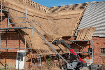 an old farmhouse is newly covered with reed