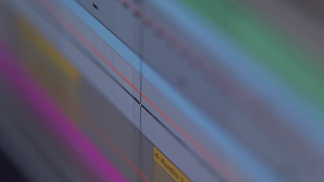 Audio track waveforms playing in music production software at home studio