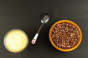 Concept of getting up to work. Morning awakening. Coffee beans on wooden table.