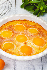 Peach Clafoutis in ceramic pie dish. Close up
