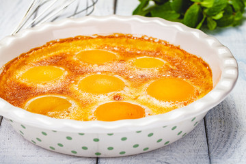 Peach Clafoutis in ceramic pie dish. Close up