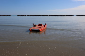 red rescue boat on the Adriatic sea, Rimini beach Italy