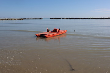 red rescue boat on the Adriatic sea, Rimini beach Italy