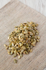 Roasted pumpkin seeds on cloth, low angle view. Closeup.