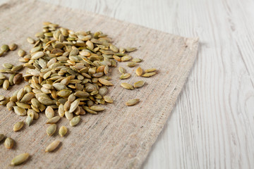Roasted pumpkin seeds on cloth, side view. Closeup.