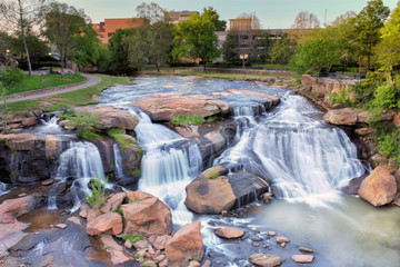 View from the Liberty bridge at a beautiful waterfall in the middle of Greenville South Carolina Falls park in the downtown.  - 267852738