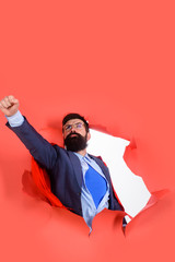 Super power. Super hero businessman through paper hole. Businessman in superhero suit under shirt. Surprised man in red superhero cape. Businessman dressed as superhero. Superhero doing fly gesture. © Svitlana