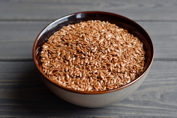 flax seeds in bowl on table background