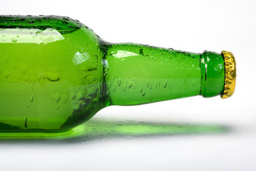 A bottle of lemonade, a close-up on white background details of glass bottle.