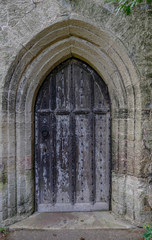 Ancient wooden door set into a stone surround.