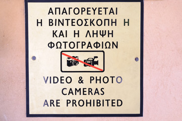 Bilingual sign in Greek and English prohibiting the use of video and photo cameras