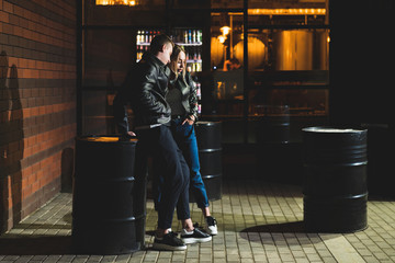 couple in love stands near the bar at night