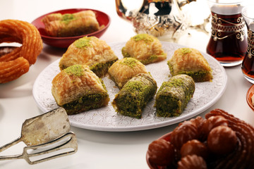 Middle eastern or arabic dishes. Turkish Dessert Baklava with pistachio on dishes