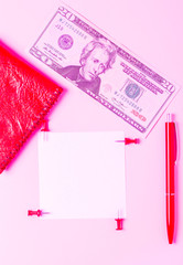 Wallet and dollars on a pink background. Business concept in coral color. Note paper in the workplace. Flat lay