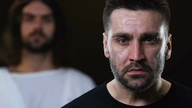 Jesus putting hand on crying man shoulder, help from heaven, faith and belief