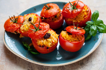 Roast tomatoes stuffed with rice, pine nuts and raisins