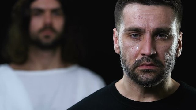 Jesus in robe putting hand on crying man head and shoulder, healing from illness