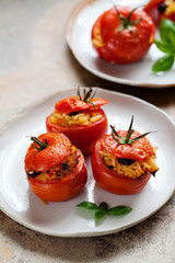 Roast tomatoes stuffed with rice, pine nuts and raisins