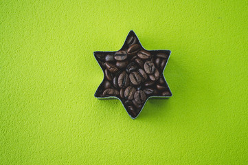 star shaped coffee beans on green blackground