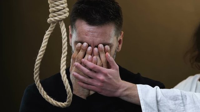 Jesus supporting crying desperate man standing near rope with hangmans noose