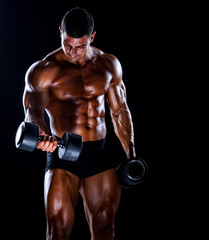 Fototapeta na wymiar Handsome Bodybuilder Lifting Weights. Execising With Dumbbells, Performing Dumbbell Biceps Curls
