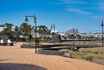 LANZAROTE, CANARY ISLANDS, SPAIN - APRIL 15, 2019: Promenade on the coastline of the resort on Lanzarote Island