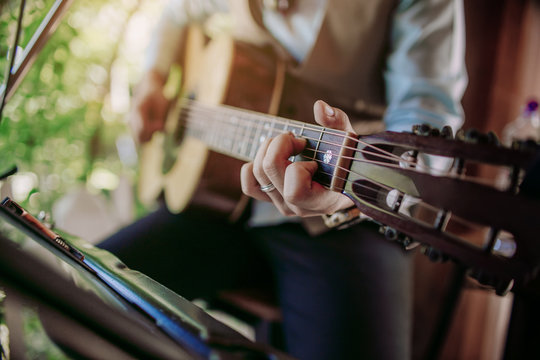 Musician playing guitar at a party.