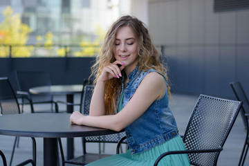 beautiful girl in a cafe on the street.emotions