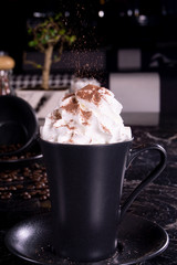 Chocolate frappe coffee with whipped cream on dark background