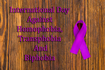 International day against homophobia, transphobia and biphobia. Purple ribbon, homophobia symbol,...