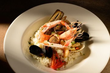 Rice with seafood on a plate in restauant ready to be served