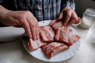 Preparing beef ribs for barbecue, raw meet 