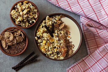 Healthy breakfast bowl with muesli, seeds and chocolate sticks. Sample breakfast for the figure and beauty.