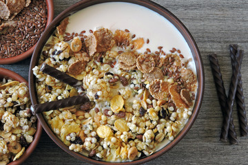 Healthy breakfast bowl with muesli, seeds and chocolate sticks. Sample breakfast for the figure and beauty.