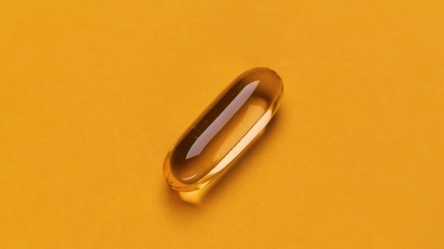 Different pills sequence. Stopmotion of few different pills on yellow background