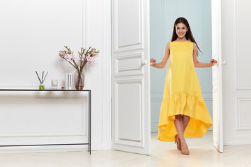 Beautiful sexy woman wear fashion summer collection clothes casual style party office skinny yellow dress code pretty model accessory jewelry brunette hair interior room door studio makeup flower.