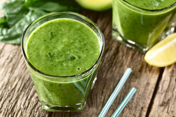 Fresh homemade vegan green smoothie made of spinach, cucumber, avocado and lemon juice (Selective...