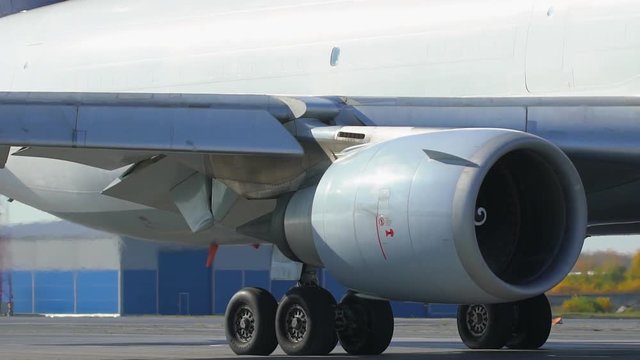 Jet turbine engine of aircraft on runway in airport. Working jet engine of passenger airliner and heat shimmer behind it. jet engine turbine turning. working airplane turbo engine. aviation security