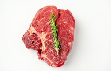 raw beef steak with herbs and spices on a white background, isolate