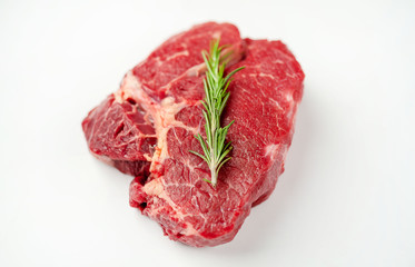 raw beef steak with herbs and spices on a white background, isolate
