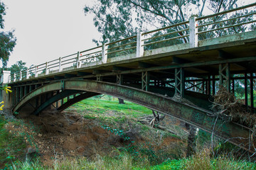 Old rusty bridge over dry riverbed