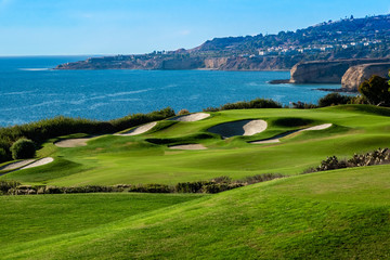 The Trump National Golf Course, in Rancho Palos Verdes along the Pacific coast of California, opened in 2006. Fairway and greens with lakes, sand traps are seen, ocean background with cliffs, bluffs. - Powered by Adobe