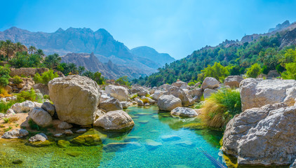 Lagoon with turqoise water in Wadi Tiwi in Oman. - obrazy, fototapety, plakaty